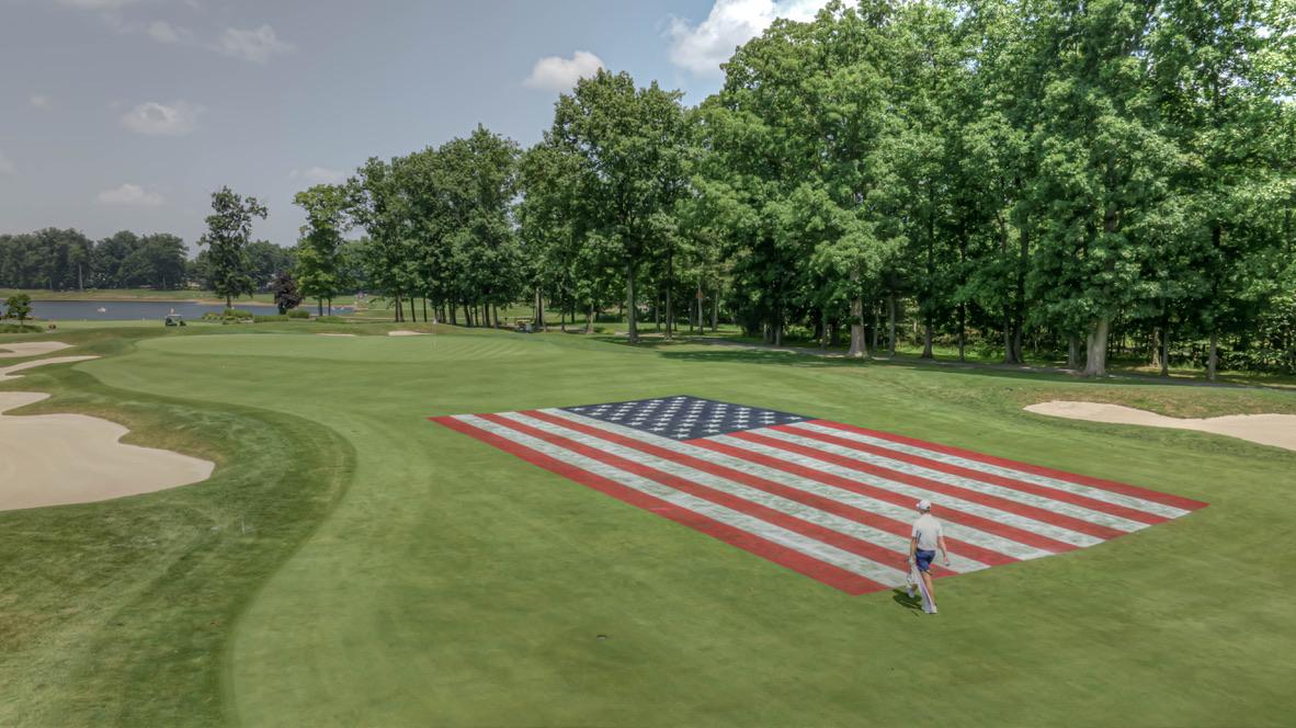Golfer walking the flag fairway — 2025 Patriot Classic